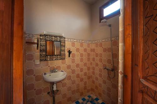 a bathroom with a sink and a mirror at Dar Adrar in Imlil