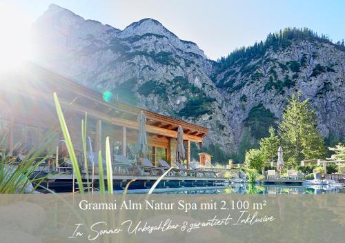 a picture of a resort with a mountain in the background at Hotel Central - das kleine Boutique Hotel am Achensee in Pertisau