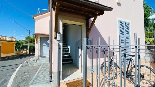 a bike parked next to a building with a gate at Babyaccommodation Family Exclusive in Borgio Verezzi
