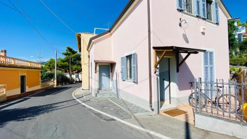 a building with a bike parked next to a street at Babyaccommodation Family Exclusive in Borgio Verezzi