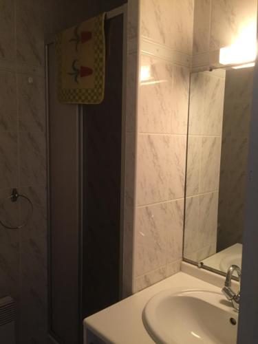 a bathroom with a sink and a mirror at Appartement Cauterets in Cauterets