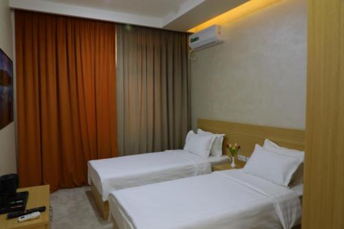 מיטה או מיטות בחדר ב-City INN Hotel