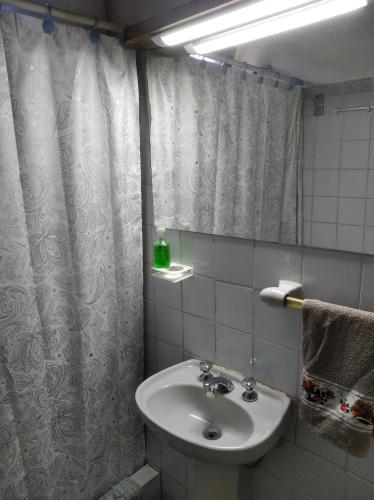 a bathroom with a sink and a shower curtain at Francais in La Paloma