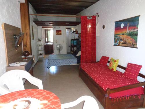 a living room with a red couch in a room at Francais in La Paloma