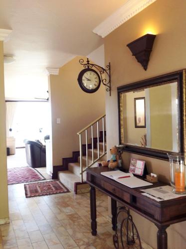 a living room with a mirror and a table at Burnham House B&B in Durban
