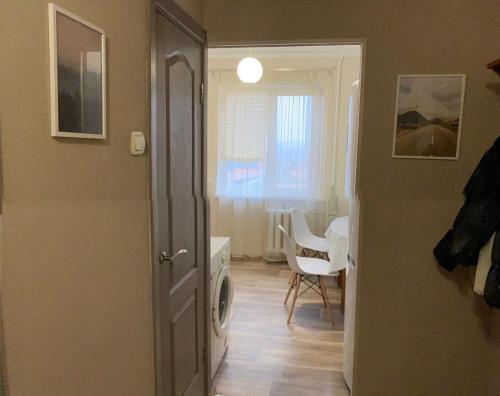 a hallway with a room with a table and a chair at Comfort House бульвар Олександрійський 125 in Bila Tserkva