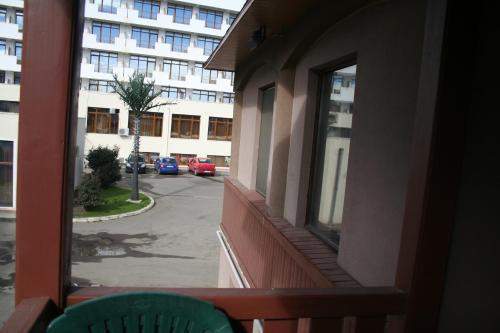 a balcony with a view of a street and a building at Vila Montana in Constanţa