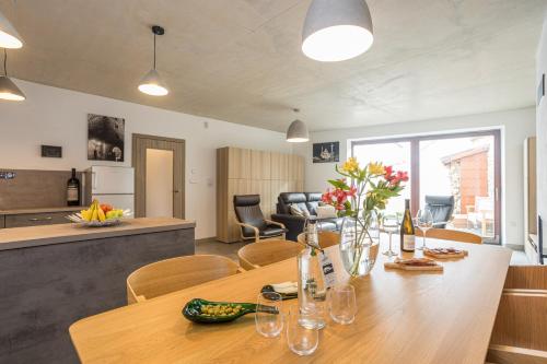 a dining room and kitchen with a table and chairs at Vinný apartmán Rakovník in Rakovník