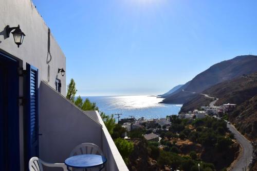 a balcony of a building with a view of the ocean at Mesohori studios in Sfakia