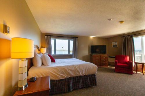 a hotel room with a bed and a large window at Dundee Resort & Golf Club in West Bay