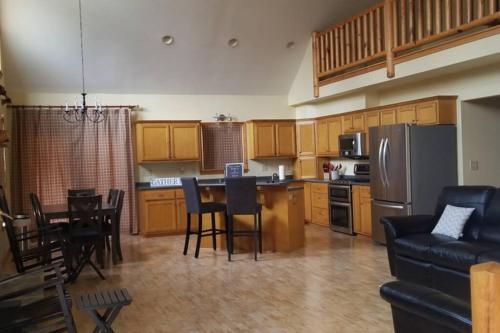 a kitchen with a table and chairs and a refrigerator at Beautiful Tranquil Mountain Home in Andrews, NC in Andrews