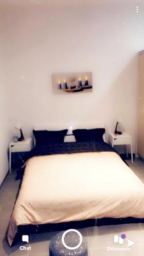 - une chambre avec un grand lit et 2 tables dans l'établissement Eyssam d’or, à Dijon