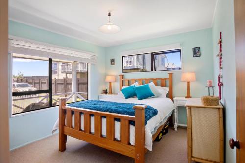 a bedroom with a bed and a window at Coastal Charm - Waihi Beach Holiday Home in Waihi Beach