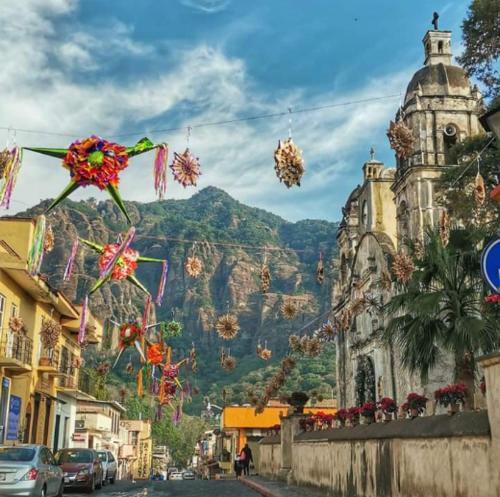 a city street with a mountain in the background at Hospedaje San Antonio Tepoztlán. in Tepoztlán