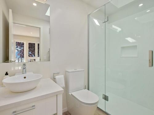 a bathroom with a toilet and a sink and a shower at Stonehill Villa - 3 Bed in Queenstown