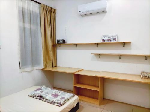 een kamer met een bureau en een raam bij OOI Homestay Alor Setar in Alor Setar