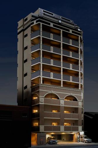 a tall building with a car parked in front of it at Coruscant Hotel NagasakiekiⅡ in Nagasaki