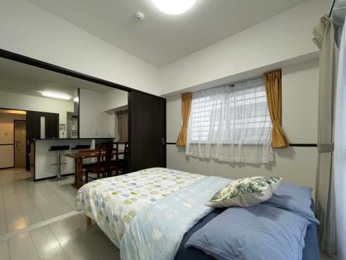 EX Itoman Apartment 201 tesisinde bir odada yatak veya yataklar