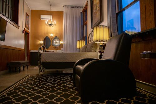 a living room with a bed and a window at School 31 Lofts in Rochester