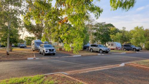 a group of cars parked on the side of a road at Cobar Caravan Park in Cobar