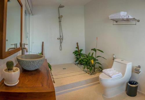 a bathroom with a sink and a toilet at The B Resort in Kampot