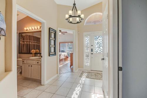 a home hallway with a sink and a mirror at Two Master Bedrooms Pool Home Private Yard in Orlando