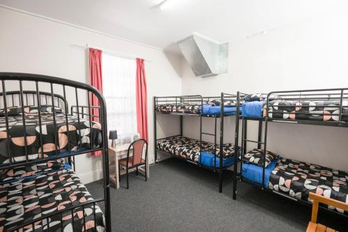 a room with three bunk beds in a dorm at Dolphin Retreat Bunbury in Bunbury