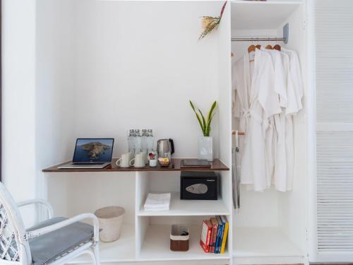 a room with a white closet with a laptop on a shelf at Granada Beach Resort - Adults Only in Boljoon