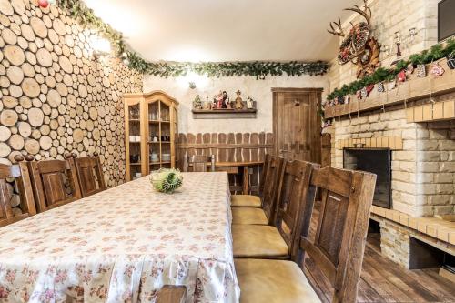 a dining room with a table and a fireplace at Маєток "ZYMON & SKI" in Bukovel
