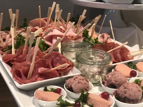 a tray of different types of food on a table at Hotel Leegerpark in Greetsiel