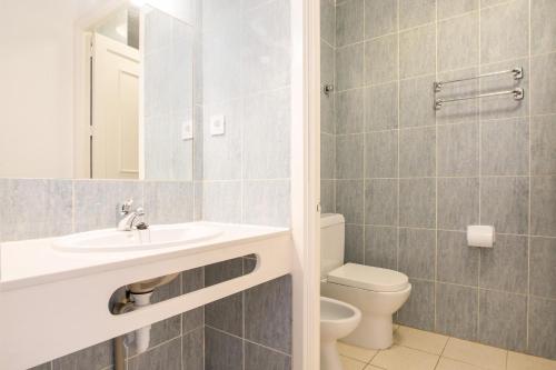a bathroom with a sink and a toilet at Palm Garden with sea views to the pools and beach in Morro del Jable