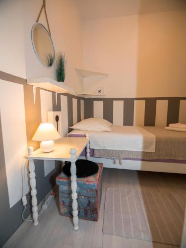 a small bedroom with a bed and a table at Apartment Eneja in Rab
