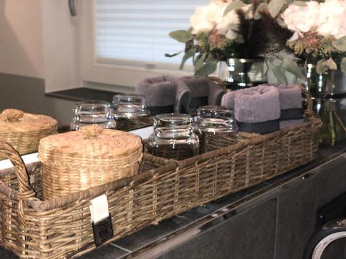 a basket sitting on top of a counter with glasses at Hotel Leegerpark in Greetsiel