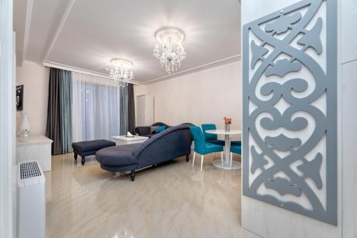 a living room with a blue couch and a table at Adonis Zlatibor 205 in Zlatibor