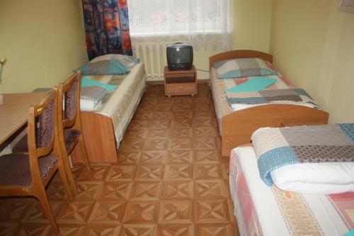 A bed or beds in a room at Hostelis Priekuļi