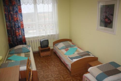 A bed or beds in a room at Hostelis Priekuļi