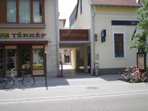 a street with shops and buildings in a town at Mediterrán Szállás in Gyula