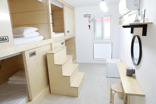 a small room with a staircase and a mirror at Minihotel Poongdaengi in Gyeongju