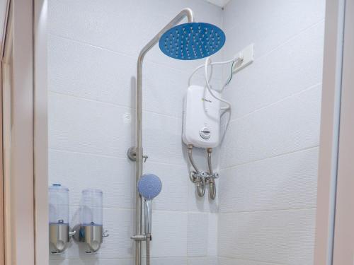 a shower with a shower head in a bathroom at Our Story Boutique Hotel in Cagayan de Oro