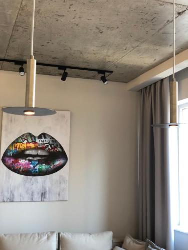 a living room with a couch and a painting on the wall at Arcadia in Odesa