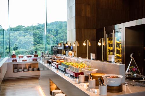 a restaurant with a buffet line with food at Grand Walkerhill Seoul in Seoul