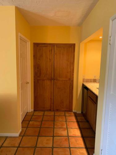 a kitchen with a door and a tile floor at La Maison Hotel - Adults Only in Palm Springs
