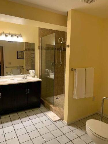 a bathroom with a shower and a sink and a toilet at La Maison Hotel - Adults Only in Palm Springs