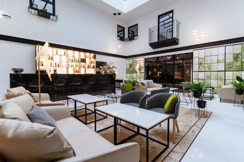 a lobby with couches and tables and a bar at The Embassy Valletta Hotel in Valletta