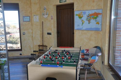 a room with a table with a billiard at Casa Rural & SPA Mirador Gredos in Guijo de Ávila
