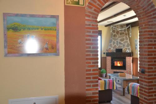 a living room with a brick archway and a fireplace at Casa Rural & SPA Mirador Gredos in Guijo de Ávila