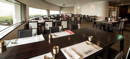 a dining room with tables and chairs and a cafeteria at Grand Walkerhill Seoul in Seoul