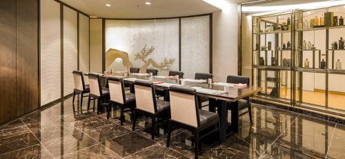 a conference room with a long table and chairs at Grand Walkerhill Seoul in Seoul