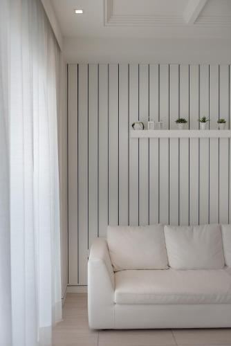 a living room with a white couch and a window at Hotel San Marco in Cattolica