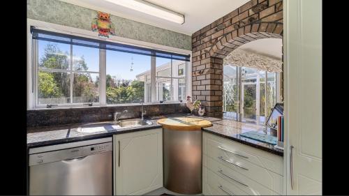 a kitchen with a sink and a window at Amy's Forest City Villa in Rotorua